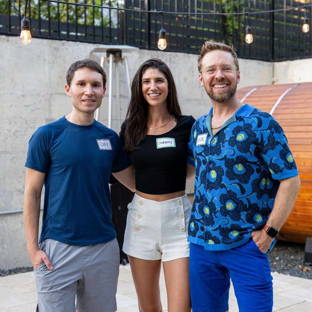 Nick with Courtney and a friend at a backyard party, all wearing name tags