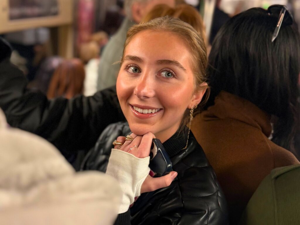 Jamie smiling on a New York City subway train